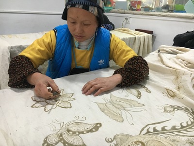 Femme Miao dessinant un motif de batik à la cire